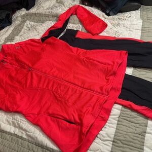 Coral and black colored under armor workout outfit top is size large.